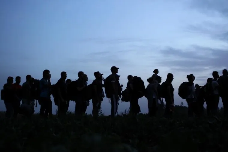 Izbjeglice cijeli dan ilegalno prelaze granicu RH kod Tovarnika. Iako je pao mrak ljudi i dalje po mraku kroz polje ulaze u Hrvatsku. Hrvatska policija čeka ih u polju, te policijskim kombijima prevozi u policijsku postaju Tovarnik.