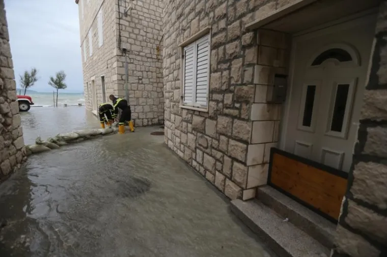 Olujno jugo poharalo ka&scaron;telanski zaljev. Vatrogasci grade zečji nasip.