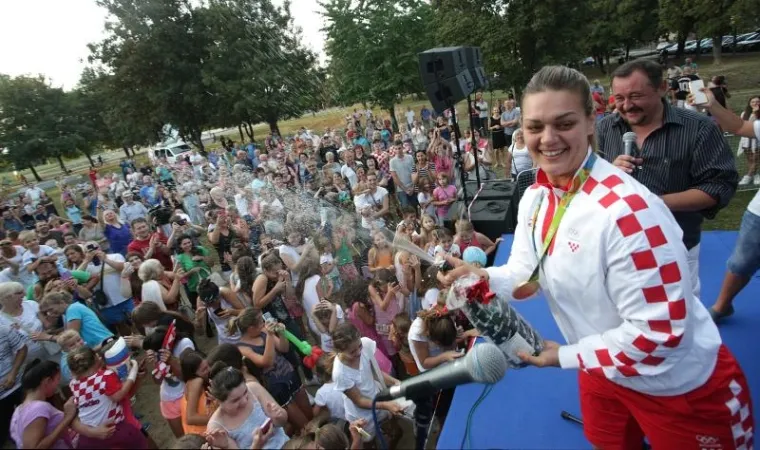 Olimpijska pobjednica u bacanju diska Sandra Perković dočekana je u svome kvartu, zagrebačkoj Dubravi. Brojni navijači i tambura&scaron;i zapjevali su zlatnoj Sandri, a na&scaron;la se tu i torta i neizbježni &scaron;ampanjac.