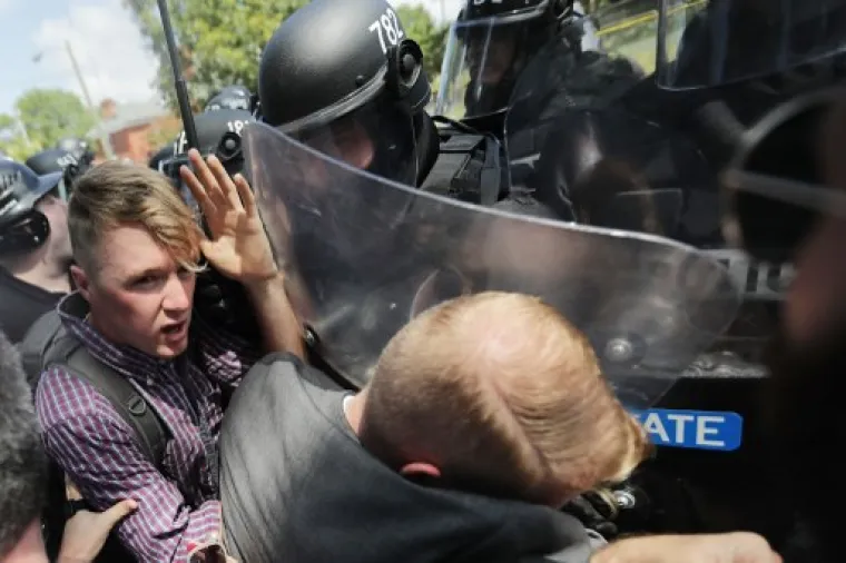 CHARLOTTESVILLE, VA - AUGUST 12: White nationalists, neo-Nazis and members of the "alt-right" are forced out of Lee Park after the "Unite the Right" rally was declared an unlawful gathering August 12, 2017 in Charlottesville, Virginia. After clashes with anti-fascist protesters and police the rally was declared an unlawful gathering and people were forced out of Lee Park, where a statue of Confederate General Robert E. Lee is slated to be removed.   Chip Somodevilla/Getty Images/AFP