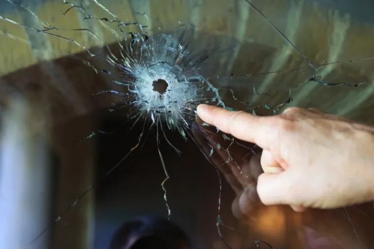Nakon talačke krize u naselju Šećerana u Baranji u kojoj se muškarac s ručnom bombom zatvorio u stan, policija je zatvorila sve prilaze selu, obavlja očevid dok susjedi u nevjerici pregledavaju ostećenja od metaka.