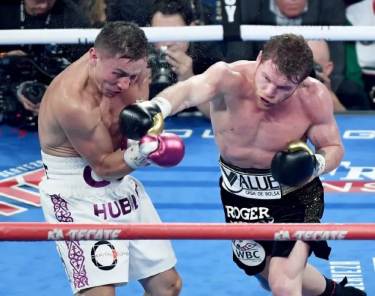 LAS VEGAS, NV - SEPTEMBER 15: Canelo Alvarez (R) throws a right at Gennady Golovkin in the fifth round of their WBC/WBA middleweight title fight at T-Mobile Arena on September 15, 2018 in Las Vegas, Nevada. Alvarez won by majority decision.   Ethan Miller/Getty Images/AFP