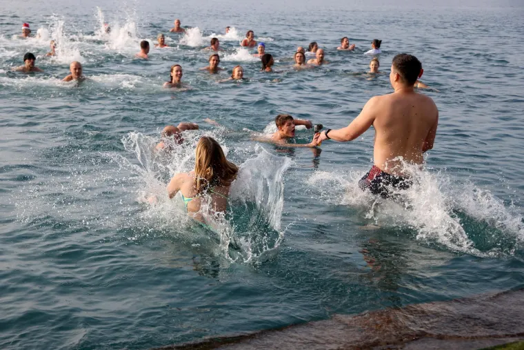 Tko se boji zime jo&scaron;? Hrabri kupači s kapicama i &scaron;ampanjcem u moru proslavili Novu