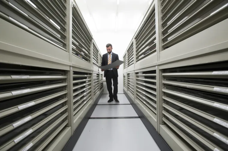 U modernoj čitaonici sjede istraživači uz svoje laptope i pregledavaju drevne dokumente i knjige čiji je papir već požutio od starosti.