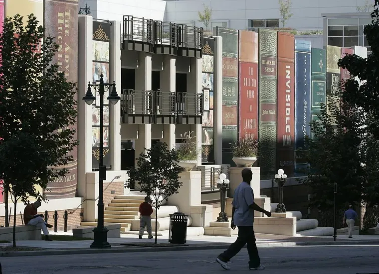JAVNA KNJIŽNICA KANSAS CITYJA - Južni zid parkirne garaže Središnje knjižnice u Kansas Cityju izgleda kao polica s divovskim knjigama. Nazvan &quot;Polica zajednice&quot;, ovaj mural dovršen 2004. prikazuje hrptove 22 knjige visoke oko 7.5 metara. Naslove su predložili građani, a uključuju klasike poput &quot;Kvake 22&quot; i &quot;Ubiti pticu rugalicu&quot;.
