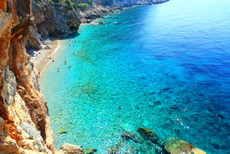 Pasjača (Konavle): Jedinstvena plaža nastala erozijom crvenkastih stijena, smje&scaron;tena ispod visokih klifova Konavala. 